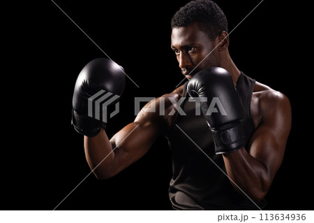 African American man in a boxing stance, with copy space African American man in a boxing stance, with copy space 113634936