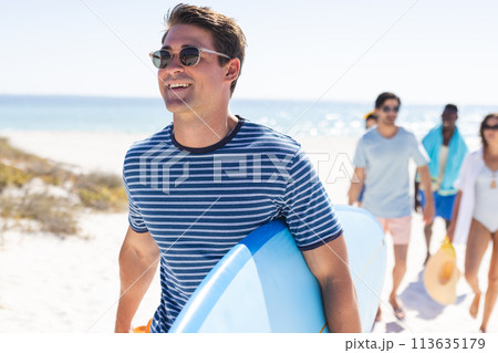 Young Caucasian man enjoys a sunny beach day Young Caucasian man enjoys a sunny beach day 113635179