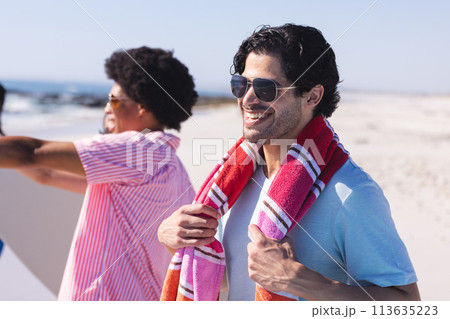 Young African American man and Biracial man enjoy a sunny beach day 113635223