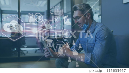 Image of financial data processing over businessman with face mask using tablet in office 113635467
