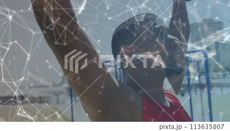 Image of network of communication over smiling male athlete lifting weights outdoors Image of network of communication over smiling male athlete lifting weights outdoors 113635807