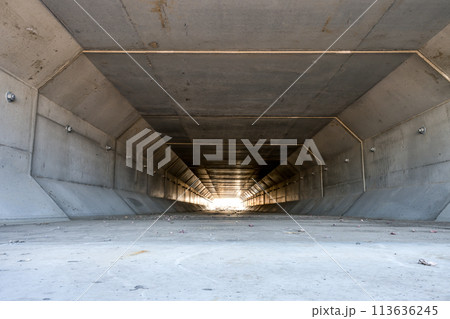 Focus stacked image inside a concrete box culvert under a road for stormwater drainage.  113636245