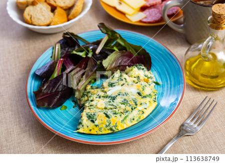 Appetizing breakfast omelette with spinach 113638749