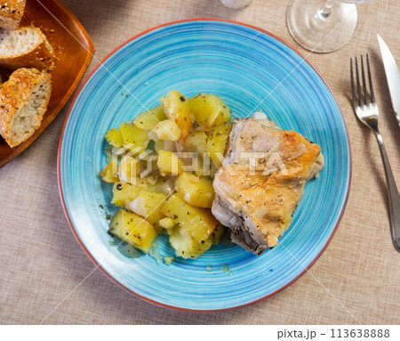 Appetizing fried pork with potatoes and spices on table 113638888