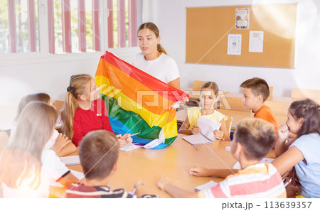 Female teacher talking about LGBT movements with preteen schoolchildren Female teacher talking about LGBT movements with preteen schoolchildren 113639357