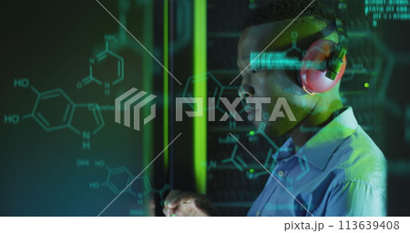 Image of data processing over african american male server room worker using headphones Image of data processing over african american male server room worker using headphones 113639408