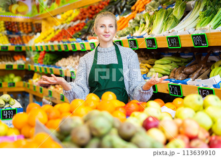 Woman store worker in apron at fruit department of supermarket 113639910