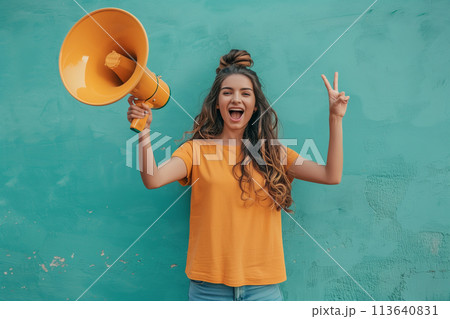 Woman Holding Yellow Bullhorn, Making Peace Sign Woman Holding Yellow Bullhorn, Making Peace Sign 113640831