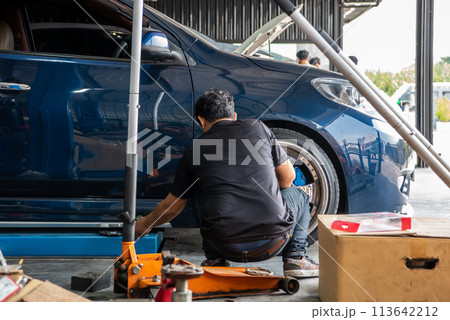 Checking car brake system for repair at car garage 113642212