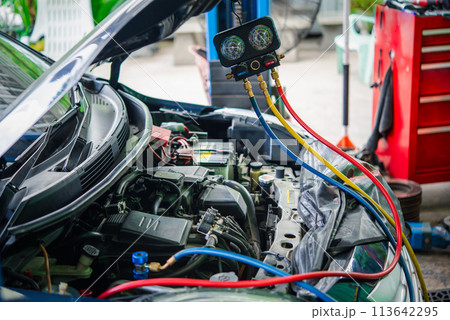 Car refilling air condition at car garage 113642295