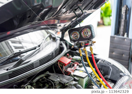 Car refilling air condition at car garage 113642329