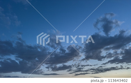Beautiful view of a blue sky at sunset with gray clouds Beautiful view of a blue sky at sunset with gray clouds 113643402