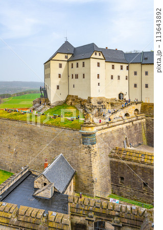 Visitors explore the historic ramparts of Konigstein Fortress in Saxony, under a cloudy sky. Germany 113643892
