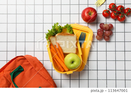 Yellow lunch box with fresh vegetables and fruits 113647001