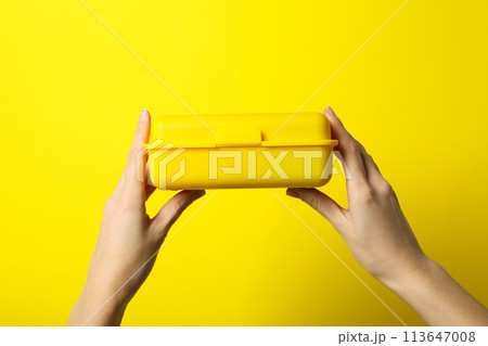 Yellow lunch box on a yellow background Yellow lunch box on a yellow background 113647008