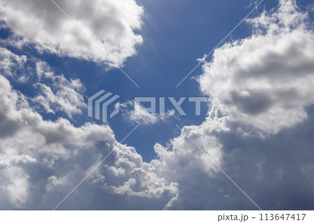 Ideal backdrop of a vibrant blue canvas with dramatic cumulus clouds for projects Ideal backdrop of a vibrant blue canvas with dramatic cumulus clouds for projects 113647417