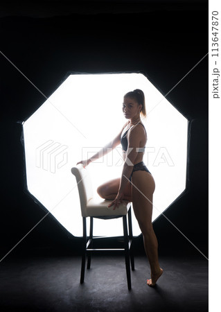 Silhouette of a beautiful young woman wearing underwear in backlight 113647870
