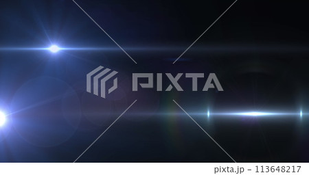 Image of spotlight with lens flare and light beams moving over dark background Image of spotlight with lens flare and light beams moving over dark background 113648217