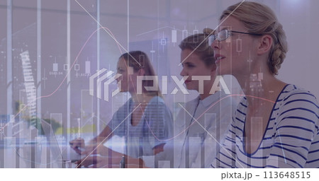 Caucasian women analyze data on a screen in an office setting 113648515