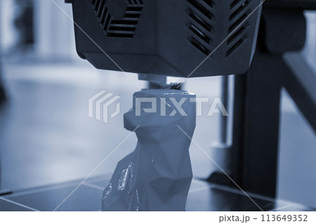 The process of printing an object with 3D printer. 3D printer printing a model from molten plastic. 3D printing. Robotic creation of mold form. Automated creation prototyping of 3D printers technology 113649352