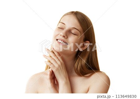 Woman gently touching her skin after beauty treatments against white studio background. Beautiful model with bare shoulders 113649830