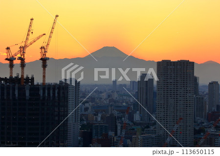 Sunset behind Mt. Fuji as seen from Minato-ku in central Tokyo Japan Sunset behind Mt. Fuji as seen from Minato-ku in central Tokyo Japan 113650115