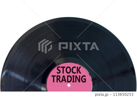 Stock trading symbol. Concept words Stock trading on beautiful black vinyl disk. Beautiful white table white background. Business stock trading concept. Copy space. 113650253