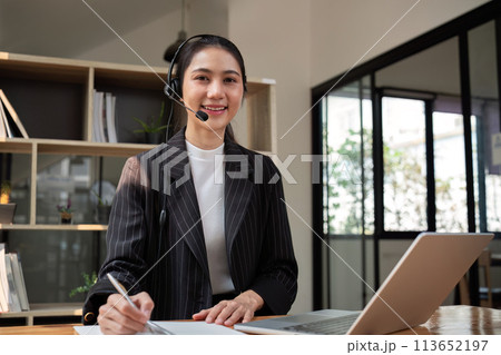 Call center agent with headset working on support hotline in office. Video conference 113652197