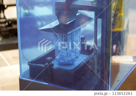 Process SLA 3D printing. Process printing on 3D printer by SLA printing technology. 3D printed object from resin polymerization. Object created on 3D printer from hardened resin. Printing technology Process SLA 3D printing. Process printing on 3D printer by SLA printing technology. 3D printed object from resin polymerization. Object created on 3D printer from hardened resin. Printing technology 113652261