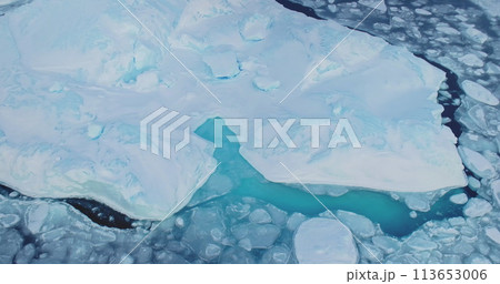 Pure ice floats in turquoise water of Antarctica. Ecology, melting ice glaciers, Arctic winter background at global warming problem. Explore icy wonders of Antarctica. Aerial drone top down view Pure ice floats in turquoise water of Antarctica. Ecology, melting ice glaciers, Arctic winter background at global warming problem. Explore icy wonders of Antarctica. Aerial drone top down view 113653006