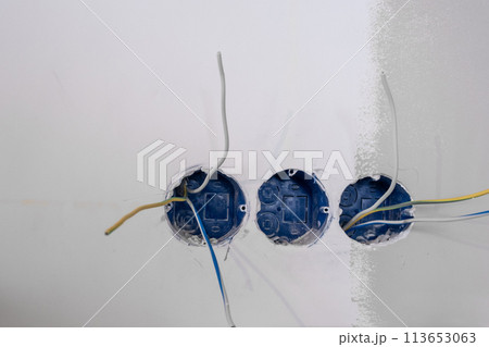 Apartment renovation. Electrical wiring. Wires sticking out of the wall. Apartment renovation. Electrical wiring. Wires sticking out of the wall. 113653063