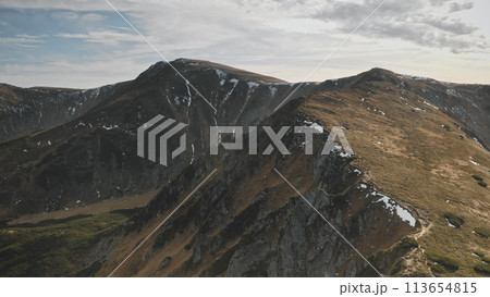 Mountain ridges at autumn aerial. Nobody nature landscape. Mountaineering vacation. Mount ranges at burned grass and moss. Cinematic tourism, travel scenery at drone shot. Carpathians, Ukraine, Europe 113654815
