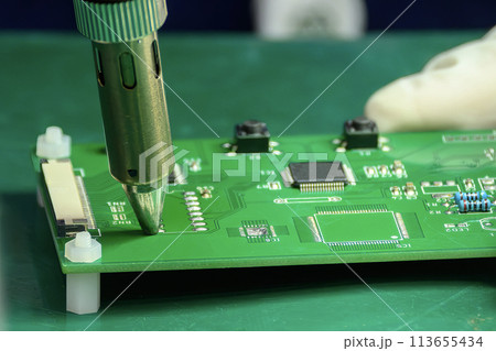 Close up scene the PCB board checking process by operator. 113655434