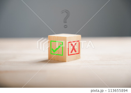 Wooden block featuring green check mark and red x. Conceptualizes choice and decision making. Think With Yes Or No Choice. 113655894