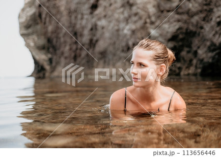 Woman travel sea. Happy tourist enjoy taking picture outdoors for memories. Woman traveler swim in the sea bay with mountains, sharing travel adventure journey Woman travel sea. Happy tourist enjoy taking picture outdoors for memories. Woman traveler swim in the sea bay with mountains, sharing travel adventure journey 113656446