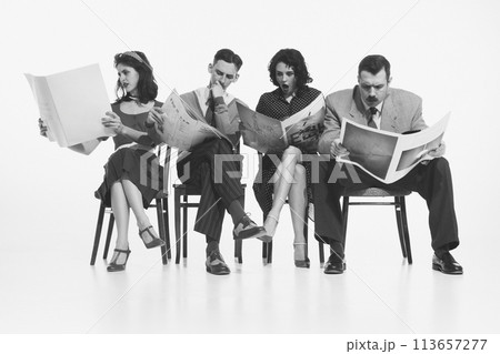Group of four people, men and women in retro-style clothes sitting on chair and reading newspapers, journals with shocked face on white background. Monochrome image. Group of four people, men and women in retro-style clothes sitting on chair and reading newspapers, journals with shocked face on white background. Monochrome image. 113657277