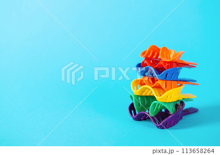 Multi-colored dental spoons for taking an impression of the dental jaw on a blue background. Making an impression of the jaw for braces and dental prosthetics, close-up. Copy space for text Multi-colored dental spoons for taking an impression of the dental jaw on a blue background. Making an impression of the jaw for braces and dental prosthetics, close-up. Copy space for text 113658264
