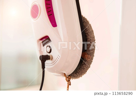 Automatic vacuum robot window washer washes glass from dirt. Modern technology and security Copy space for text Automatic vacuum robot window washer washes glass from dirt. Modern technology and security Copy space for text 113658290