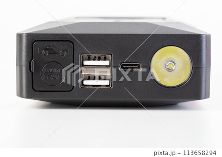 Power bank for starting a car engine with a flashlight. USB connectors, close-up 113658294