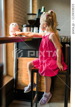 Funny baby with cochlear implant spend time cafe. Hearing aid and medicine innovating technology and diversity inclusion concept. 113659635
