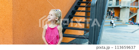 Banner child have fun with cochlear implant hearing aid in summer city. Inclusion and modern technologies for treating hearing loss. Copy space and empty space for text 113659637