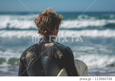 Surfer looks at the ocean while holding his surfboard at the beach. Ai generative 113660788