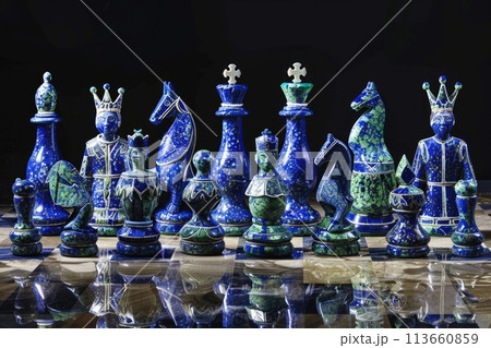 Intricately designed cobalt blue and emerald green chess set on reflective surface, symbolizing strategy and competition Intricately designed cobalt blue and emerald green chess set on reflective surface, symbolizing strategy and competition 113660859