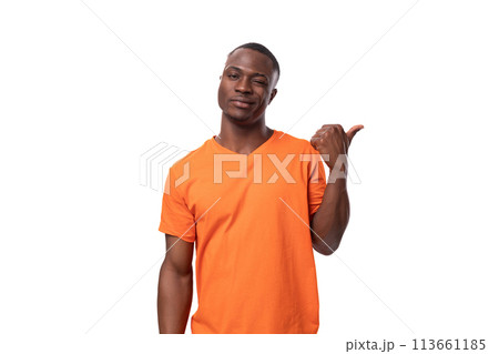 a young American guy with a short haircut dressed in an orange T-shirt is confused and doubtful a young American guy with a short haircut dressed in an orange T-shirt is confused and doubtful 113661185
