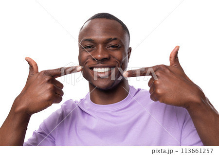 close-up portrait of a young proud american man dressed in a light lilac t-shirt on a white 113661257