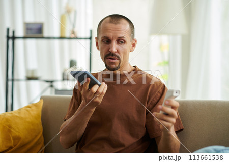 Sick man recording voice message for doctor after measuring body temperature Sick man recording voice message for doctor after measuring body temperature 113661538