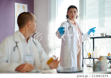 Doctor asking colleague about vaccine vial Doctor asking colleague about vaccine vial 113661874