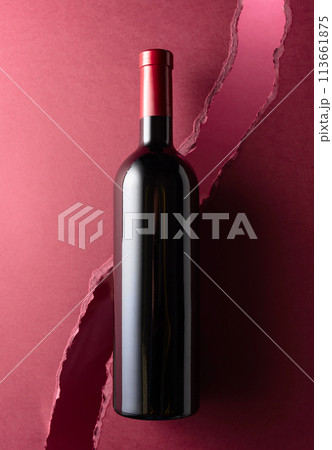Bottle of red wine on a dark red background. Bottle of red wine on a dark red background. 113661875