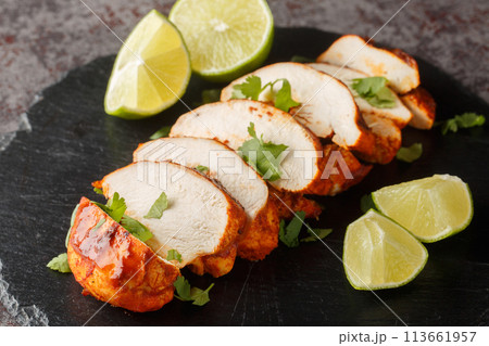 Chipotle chicken is smoky, spicy and a bit tangy from the lime juice closeup on a slate plate. Horizontal 113661957