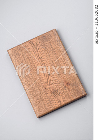 Empty wooden cutting board on gray textured concrete background Empty wooden cutting board on gray textured concrete background 113662082